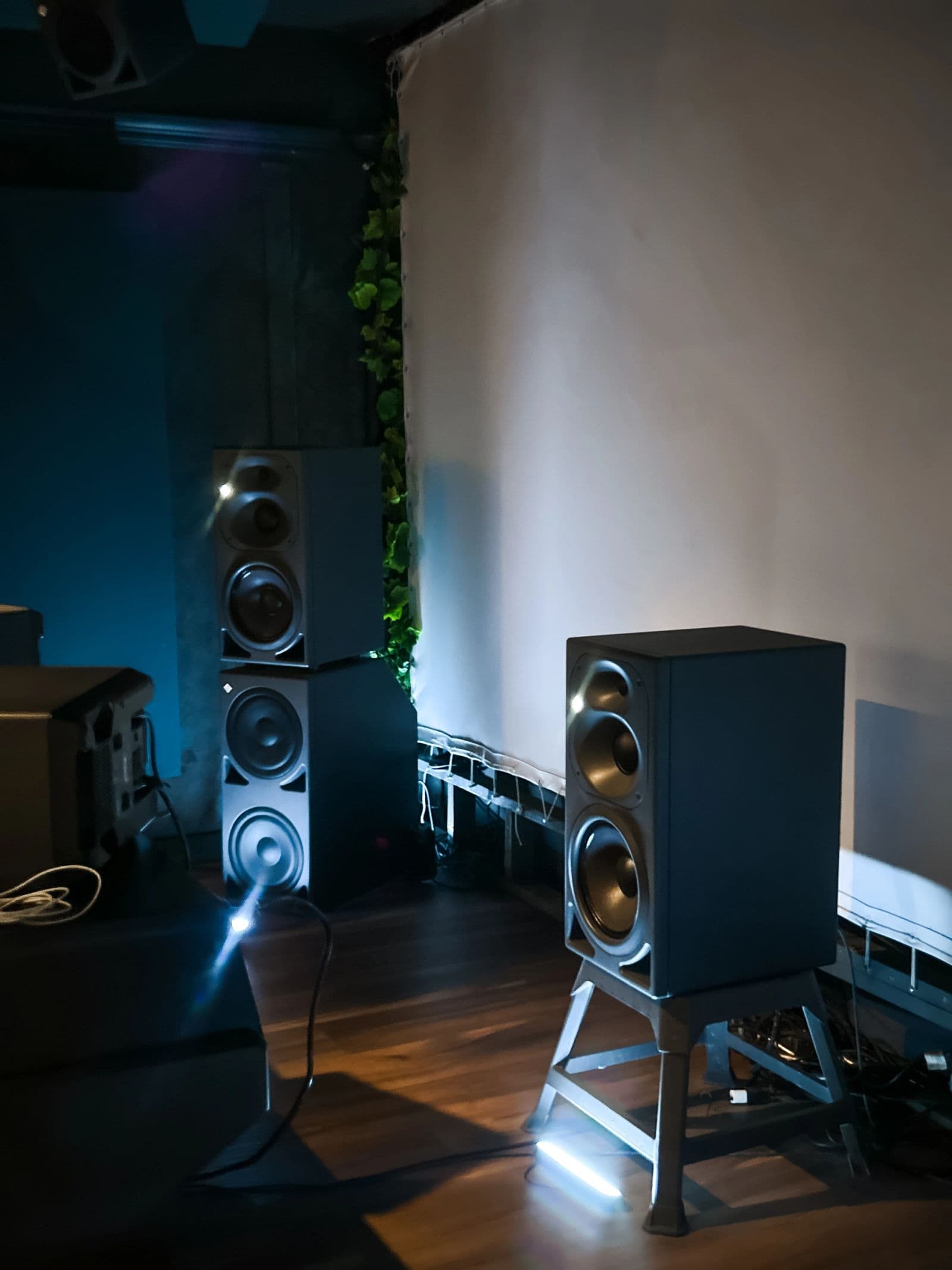 Neumann monitors on stands lit from below in the theatre